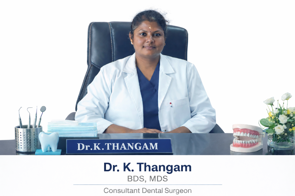 Dr. K. Thangam at desk